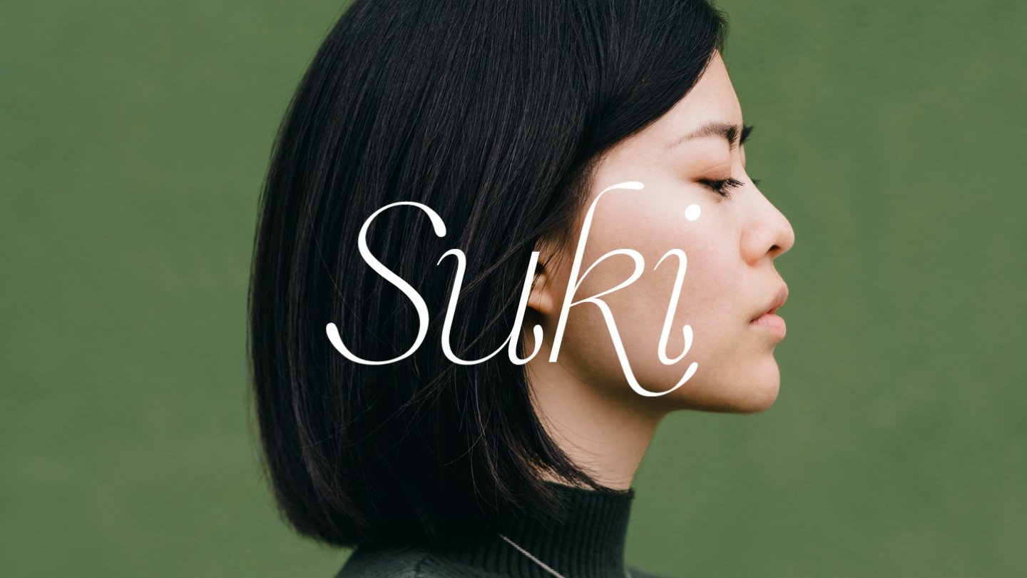 the suki logo overlaying a womens portrait.